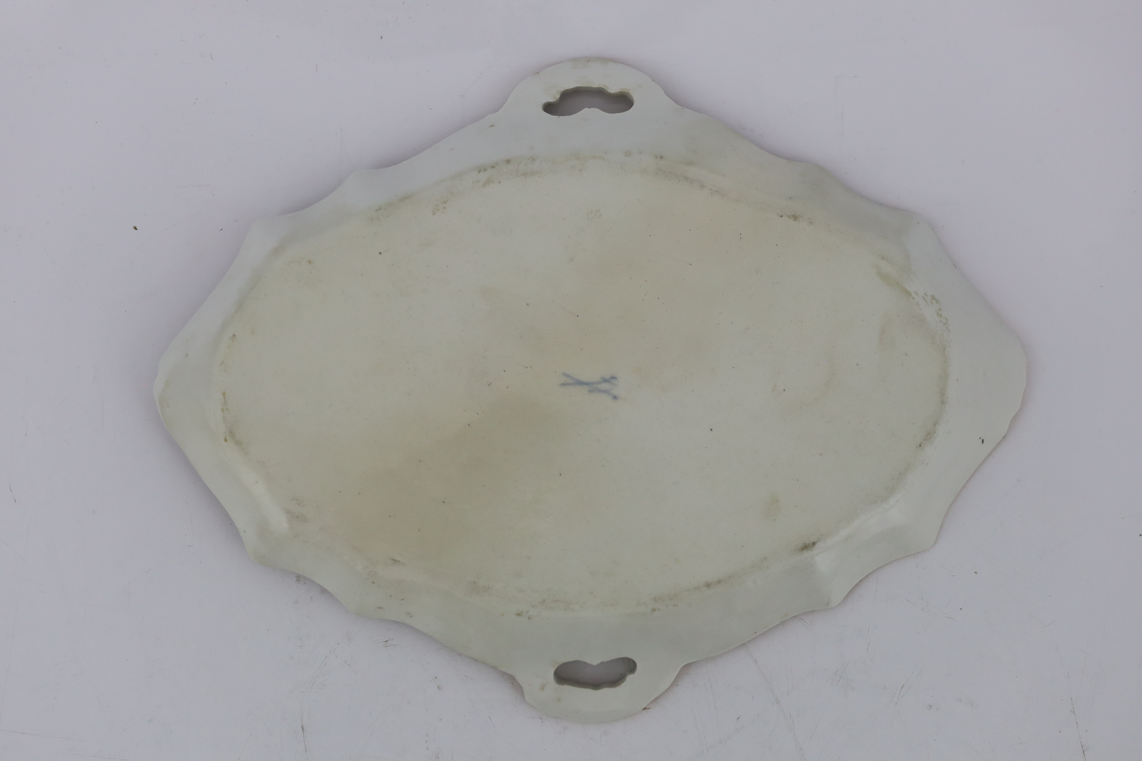 A Meissen porcelain lozenge shaped tray, 19th century, broken and restored